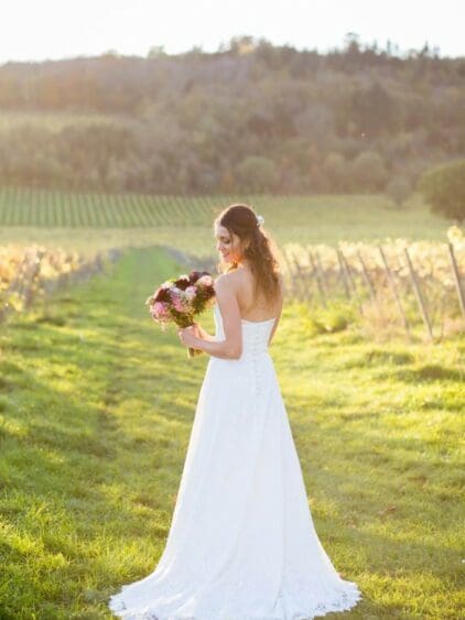 We adore the backdrop of this beautiful shot almost as much as Esther’s stunning Ivory lace gown by Lyn Ashworth. Her reception took place at a breathtaking Surrey Vineyard. Esther had a bespoke Bolero for the ceremony – more pictures of her stunning look can be seen on our Testimonials page